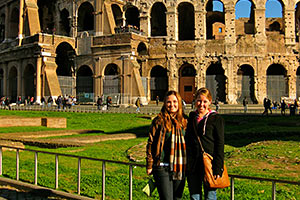 Two female students pose in front of the Roman coliseum